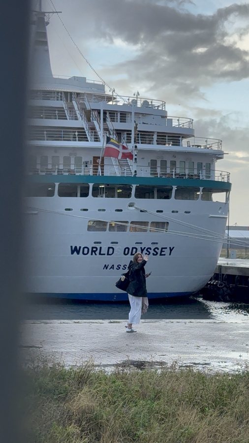 A traveler standing in front of the World Odyssey ship