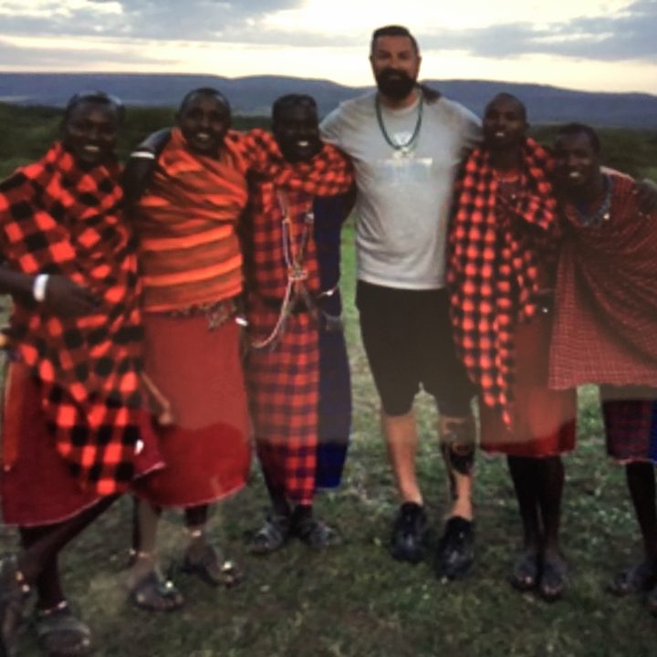 A group posing together on an open hillside