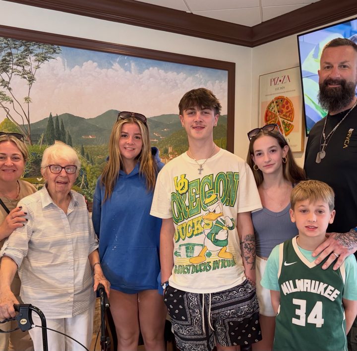 A multigenerational group posing together indoors